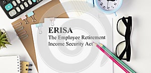 Notebook and pencil with ERISA The Employee Retirement Income Security Act words as medical concept