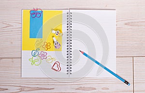 Notebook with pencil and paperclips