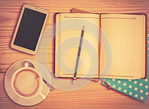 Notebook , pencil, smart phone and coffee cup with vinage filter