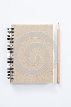 Notebook with pencil on white background