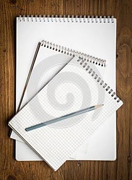 Notebook with pencile on a wood