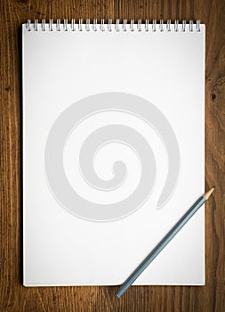 Notebook with pencile on a wood