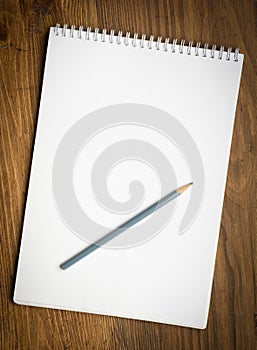 Notebook with pencile on a wood