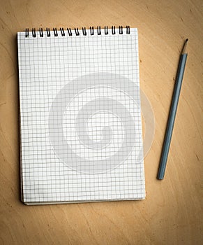 Notebook with pencile on a wooden