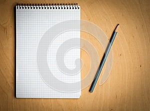 Notebook with pencile on a wooden