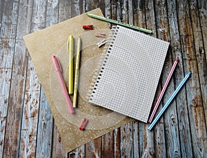 notebook, pens, pencils, ruler on the table