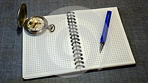 Notebook. pocket watch and pen