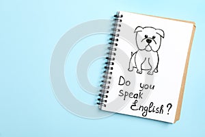 Notebook with question Do You Speak English on light blue background, top view. Space for text
