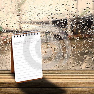 Notebook with rainy day window