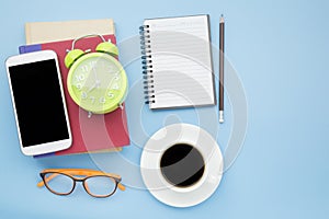 Notebook red cover mobile phone orange glasses and black coffee