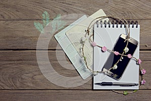 Notebook with smartphone and account book on wood background,Business concept