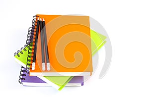 Notebook spiral bound and pencil on white background