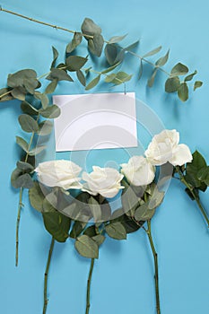 Notebook on the springs with a white rose on a blue background with an empty space for notes.