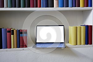 Notebook in stylish bookcase with colorful books