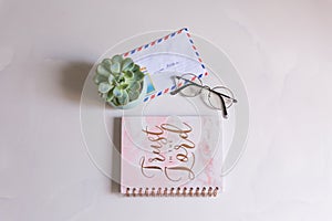 notebook surface with glasses, succulents, envelope with the inscription Russia