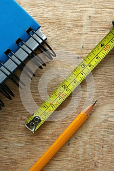 Notebook, tape measure and a pencil