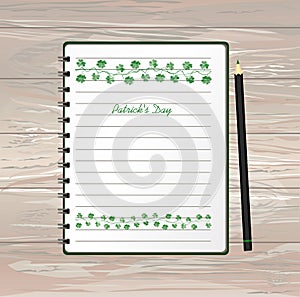 Notebook with template hand-drawn Green festive bunting with clover and pencil. Irish holiday - Happy St. Patrick`s Day