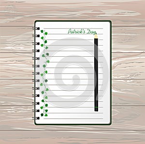 Notebook with template hand-drawn Green festive bunting with clover and pencil. Irish holiday - Happy St. Patrick`s Day