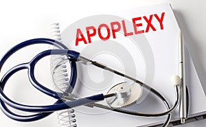 Notebook with text APOPLEXY with pen and stethoscope photo