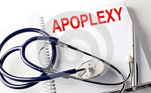 Notebook with text APOPLEXY with pen and stethoscope photo