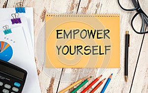 Notebook with text Empower Yourself near office supplies