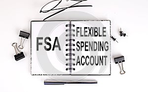 Notebook with text Flexible Spending Account FSA on a table