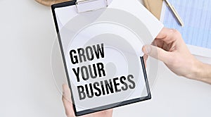 In the notebook the text of GROW YOUR BUSINESS, next to the