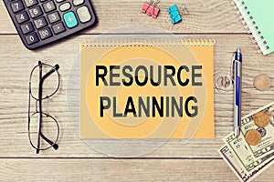 Notebook with text RESOURCE PLANNING near office supplies