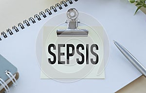 Notebook with text SEPSIS with pen and stethoscope, medicina photo