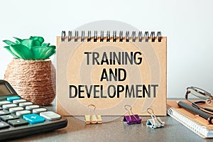 Notebook with text Training and Development near office supplies