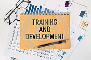 Notebook with text Training and Development near office supplies
