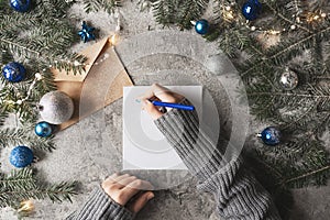 Notebook with to do list and gift boxes on wooden table.Christmas holiday background. View from above. Flat lay