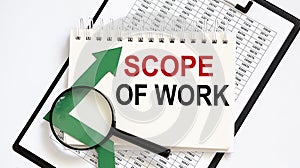 Notebook with Tools and Notes about SCOPE OF WORK with chart photo
