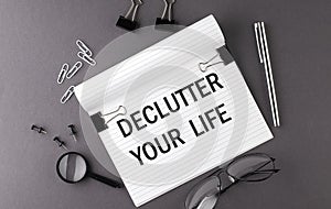 Notebook with Tools and Notes with text DECLUTTER YOUR LIFE , business concept