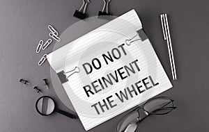 Notebook with Tools and Notes with text DO NOT REINVENT THE WHEEL , business concept