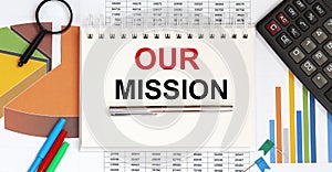 Notebook with Tools and Notes with text OUR MISSION