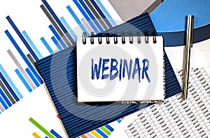 Notebook with Tools and Notes about WEBINAR ,business concept