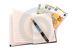 Notebook with vintage fountain pen and euro banknotes