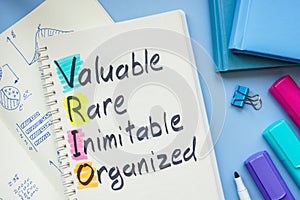 Notebook with VRIO Analysis on the desk.