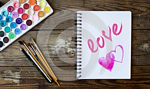 Notebook with watercolor hearts and love word