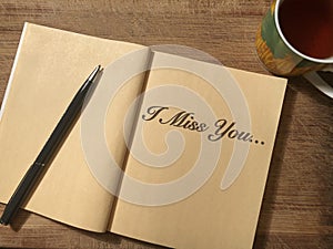 Notebook which is I Miss You written on it photo