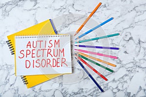 Notebook with words AUTISM SPECTRUM DISORDER photo