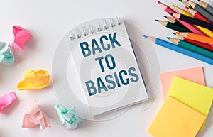 A notebook with the words Back to Basics written on it.