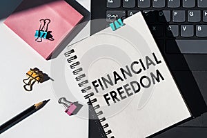 A notebook with the words financial freedom written on the cover, symbolizing the concept of achieving financial independence and