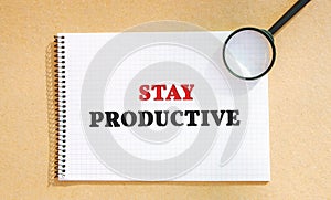 Notebook with the words Stay productive. The concept of motivation and achievement of the set goals. Organization of time.