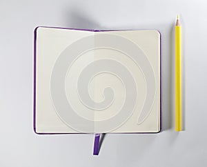 Notebook and yellow pencil