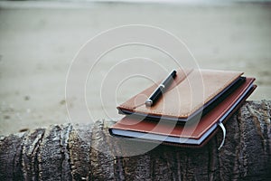 Notebooks,books and pen on the beach. photo