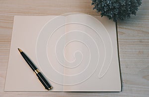 Notebooks and diary pen and planner top view wood background