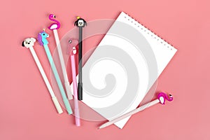 Notebooks for notes and pens on pink background