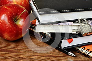 Notebooks, pen and apples